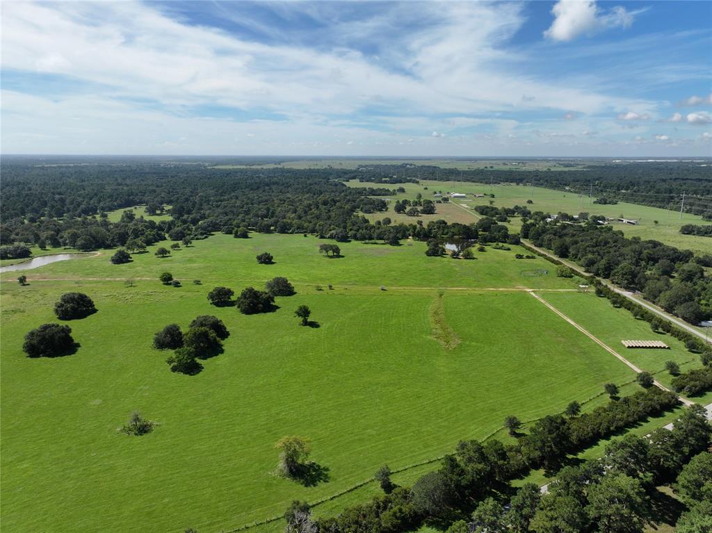 a view of a big yard with lots of green space