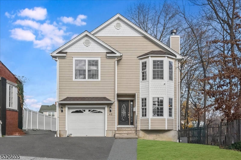 a view of a house with a yard and garage