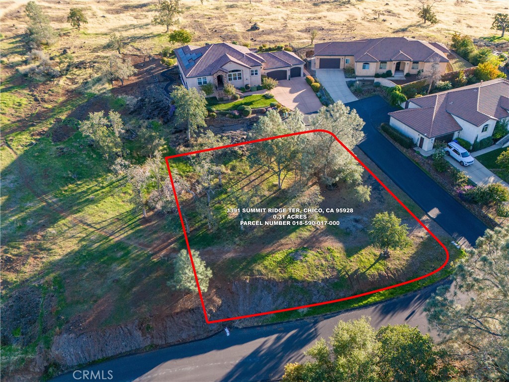 an aerial view of residential houses with outdoor space and street view