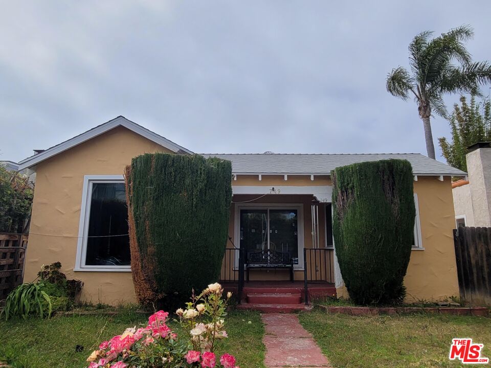 a front view of a house with garden