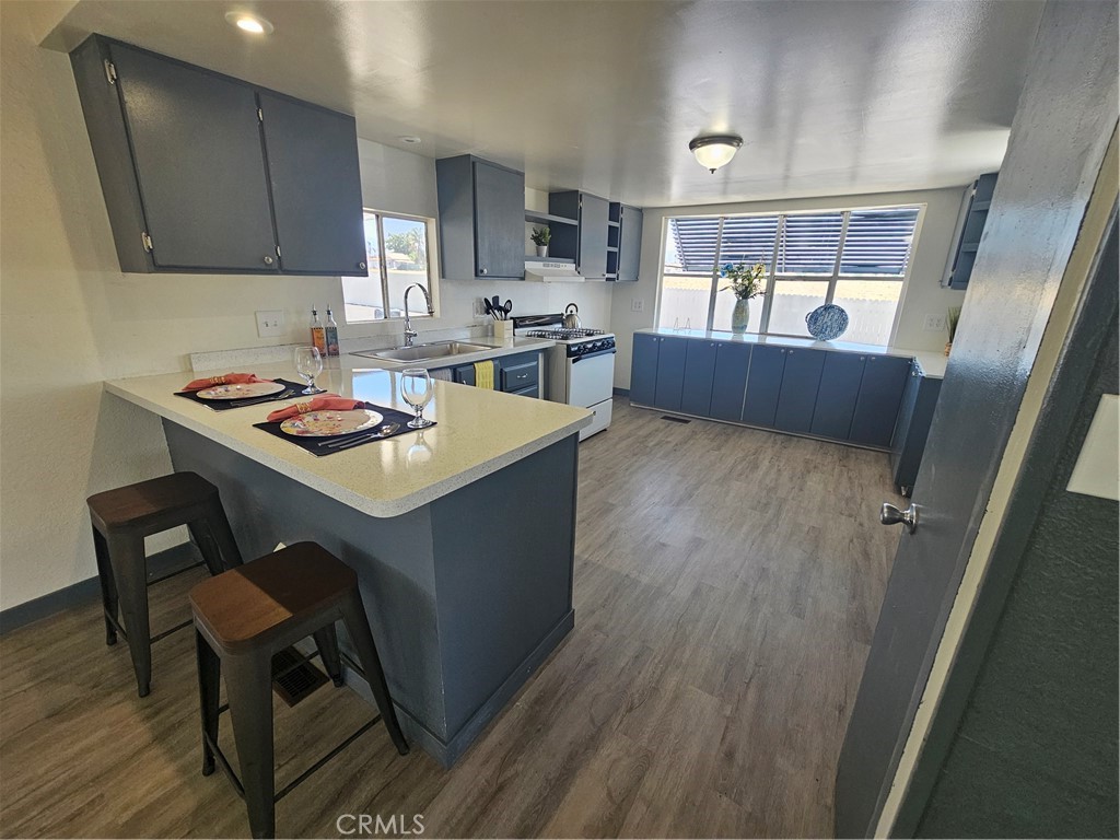 a kitchen with a wooden floor and cabinets