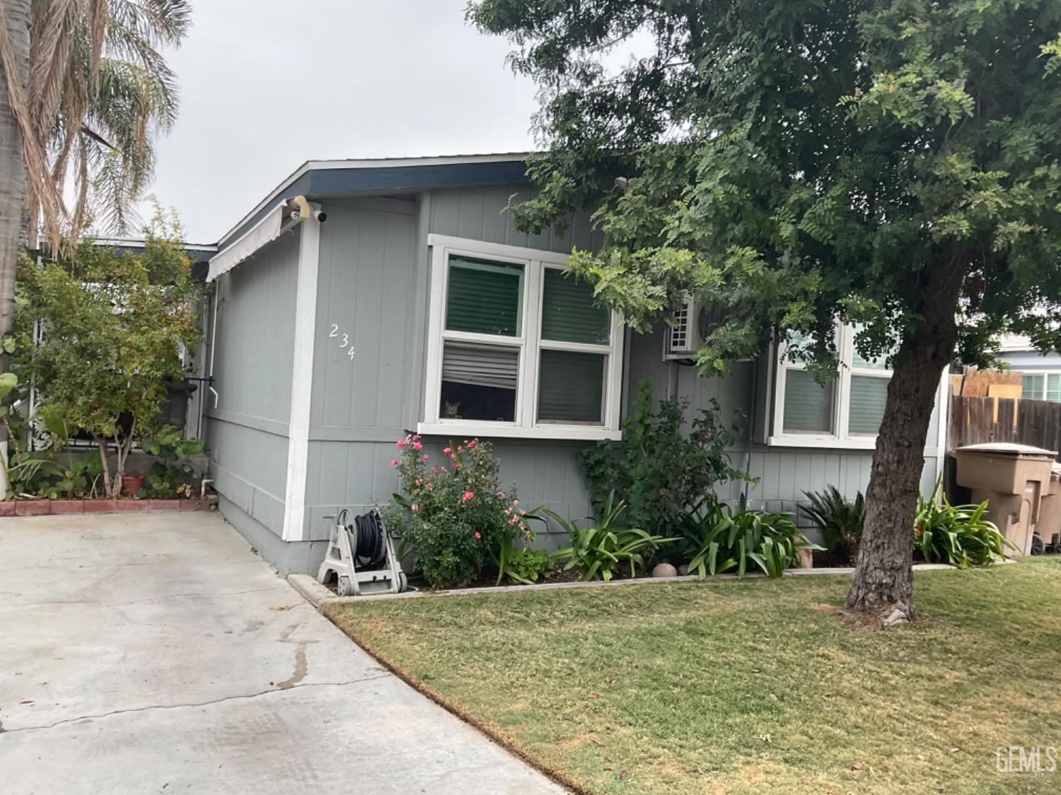 a house that has a tree in front of it