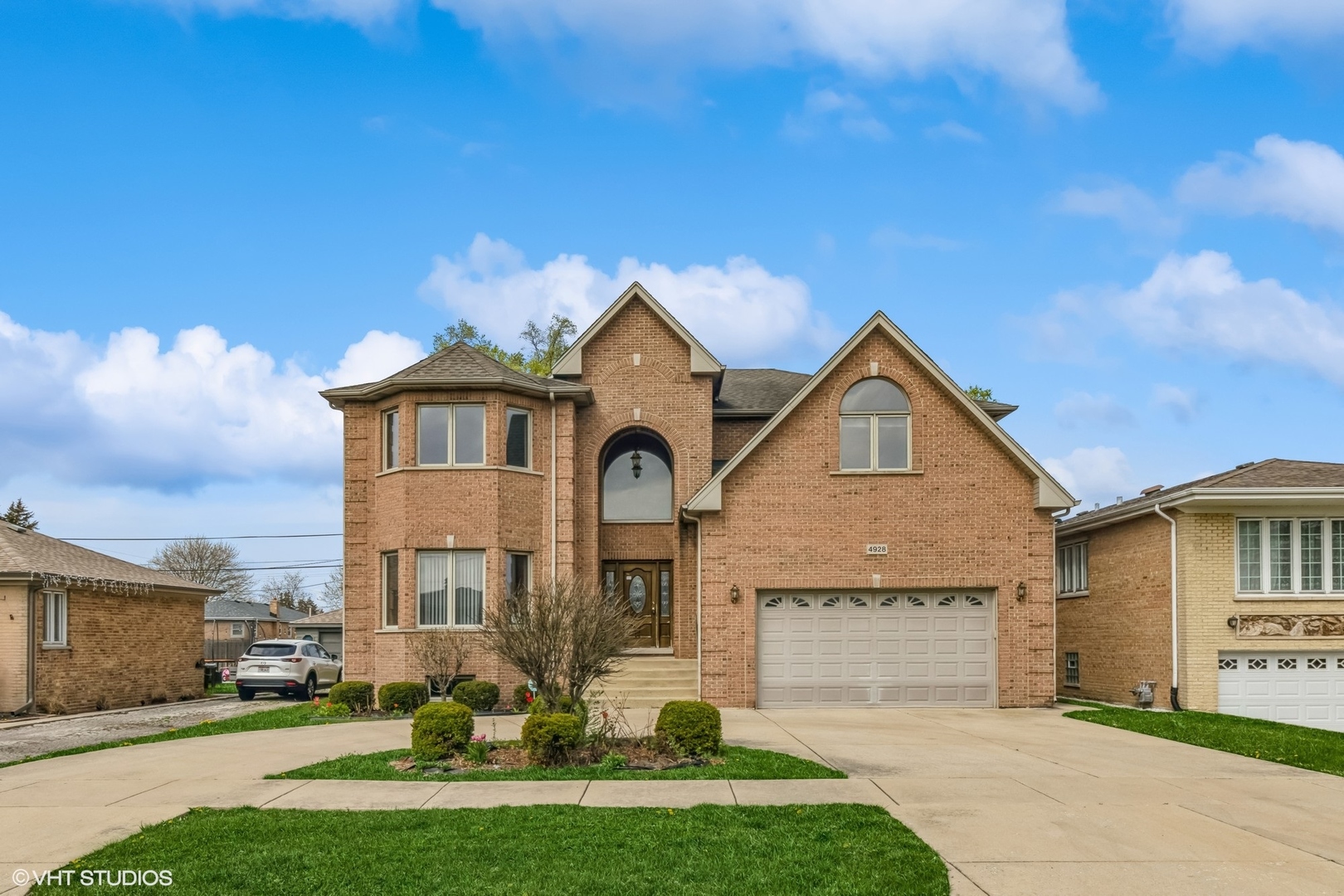 a front view of a house with a yard and garage