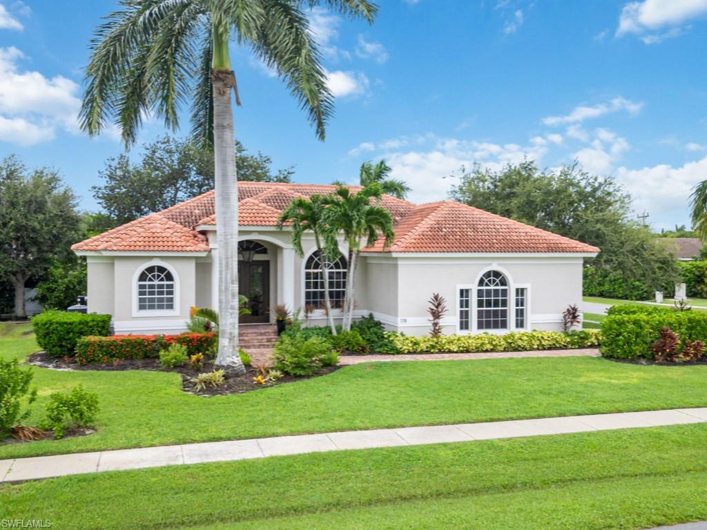 Mediterranean / spanish-style home with a front yard