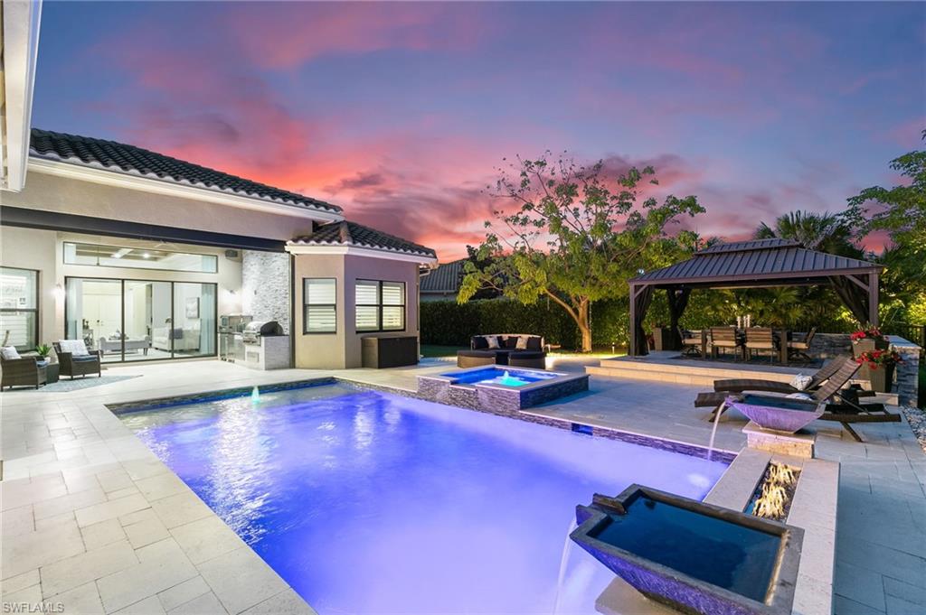 a view of a house with swimming pool and sitting area