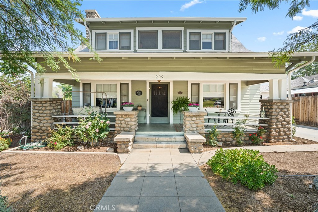 front view of a brick house with a yard