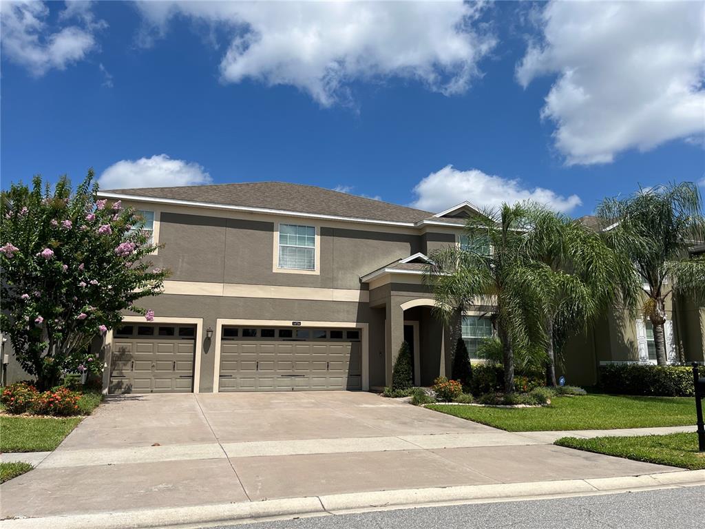 a view of a house with a patio and a yard