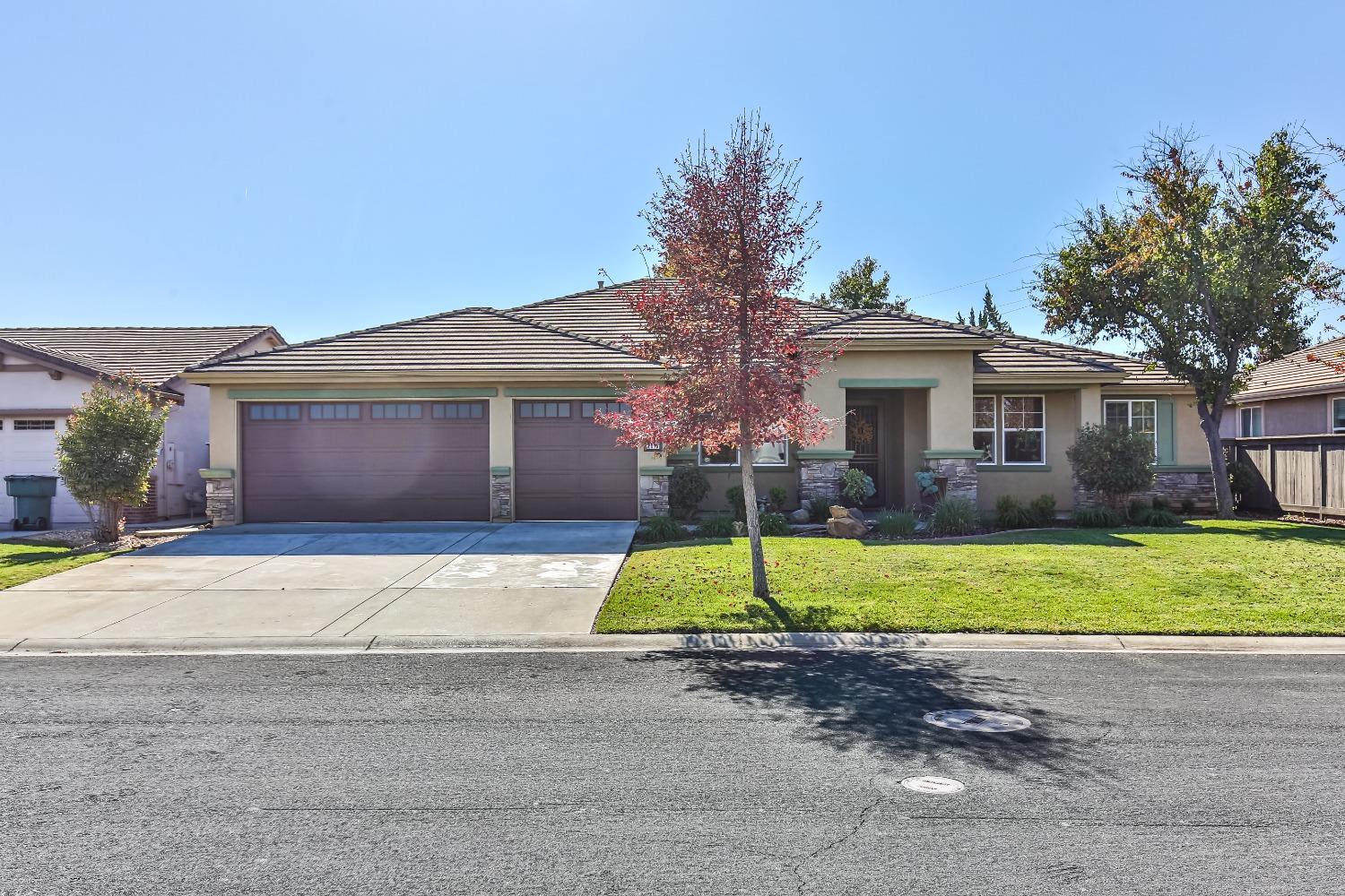 a house with a yard and a large parking space