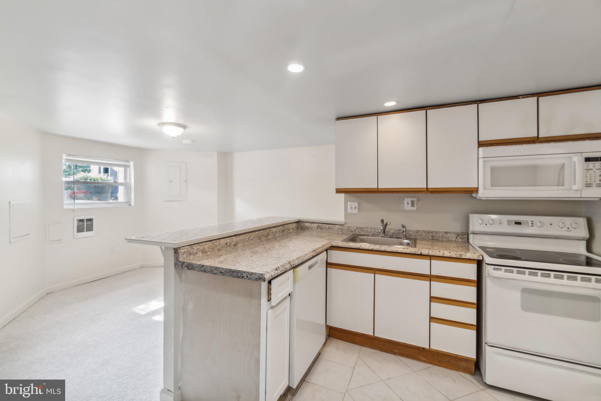 a kitchen with a sink stove and cabinets