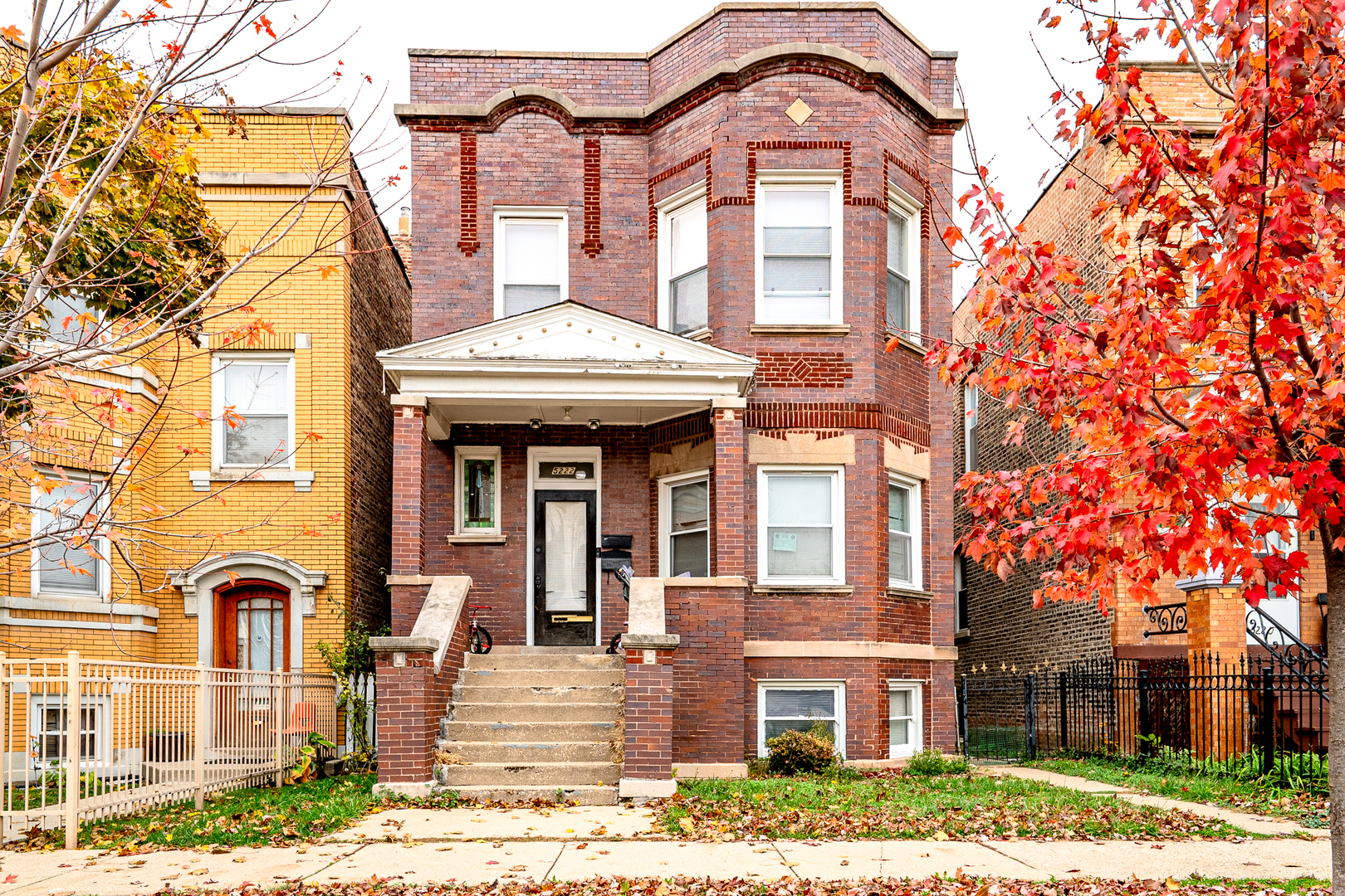 front view of a brick house with a yard