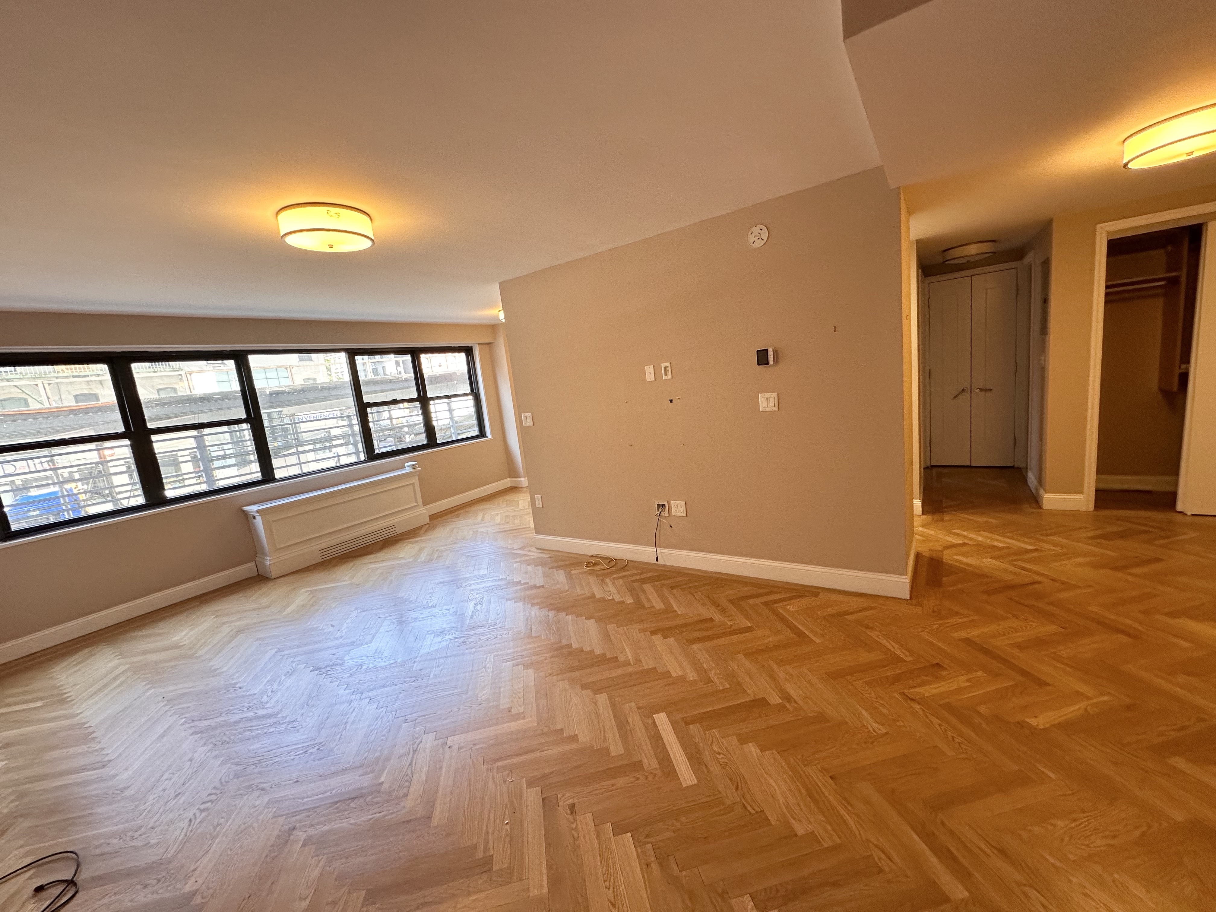 wooden floor in an empty room with a window