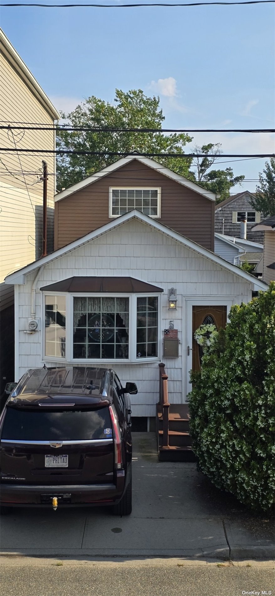 a view of a car park in front of a house