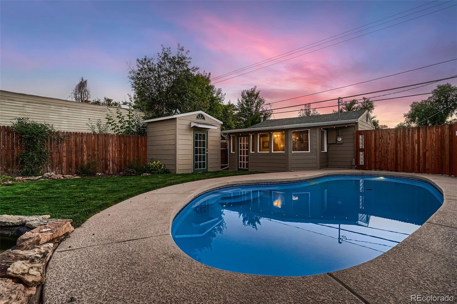 a view of a house with swimming pool and yard