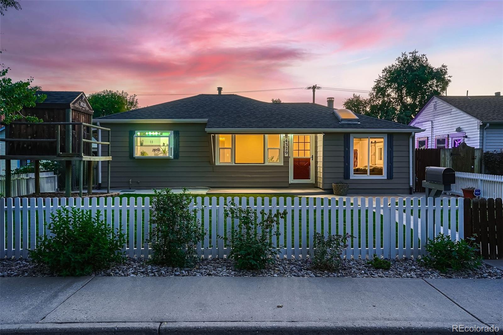 a front view of a house with a yard