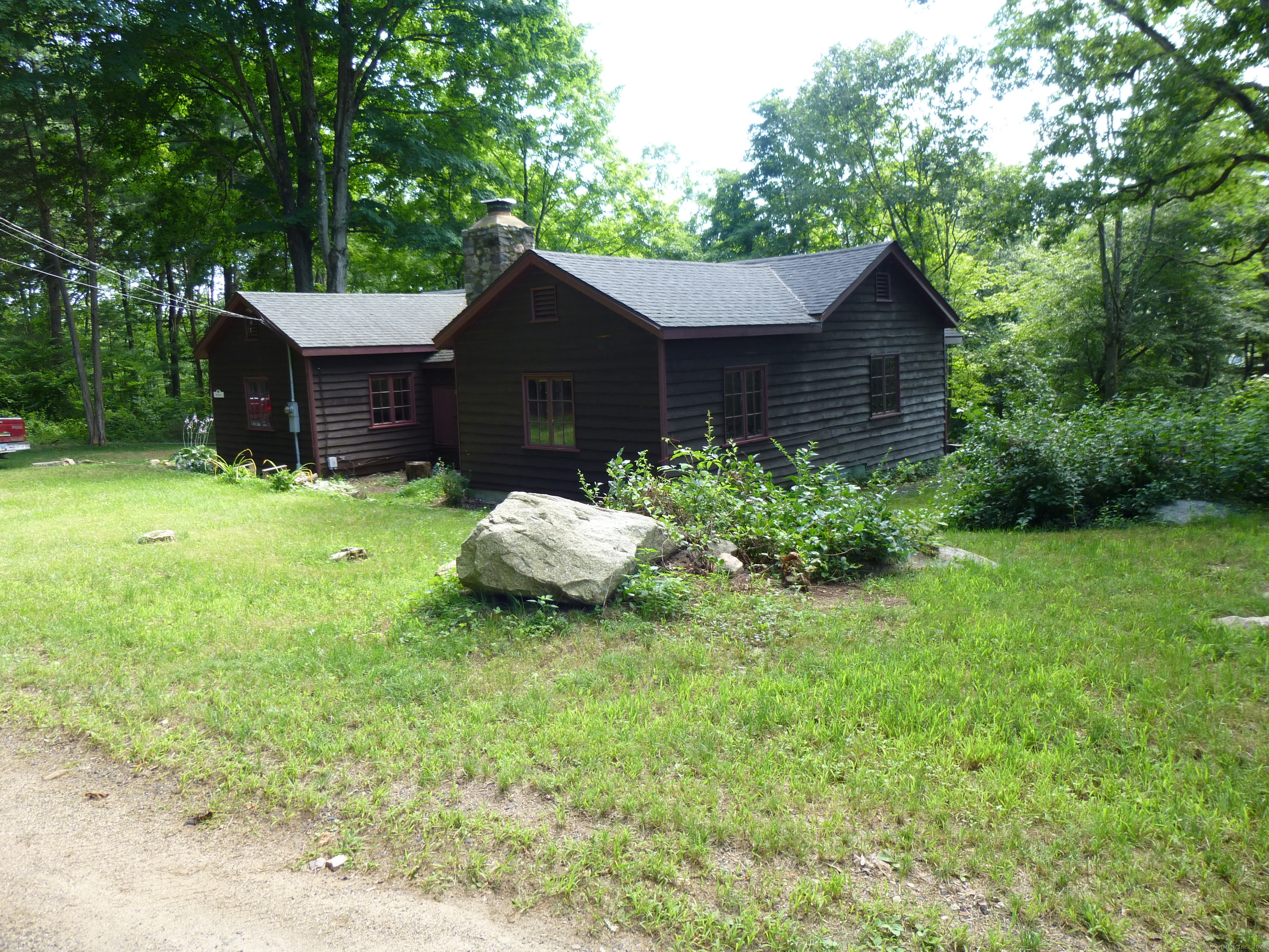 a backyard of a house with table and chairs