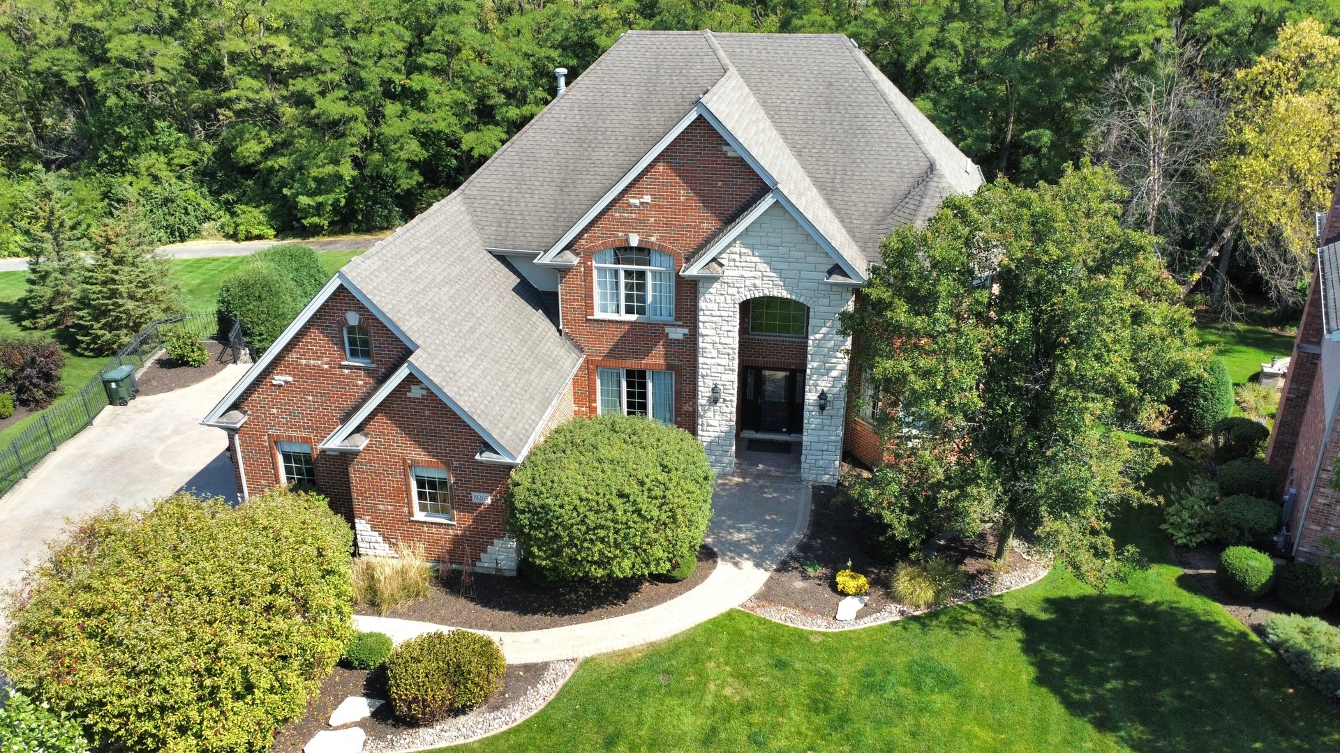 a view of a house with a yard and potted plants