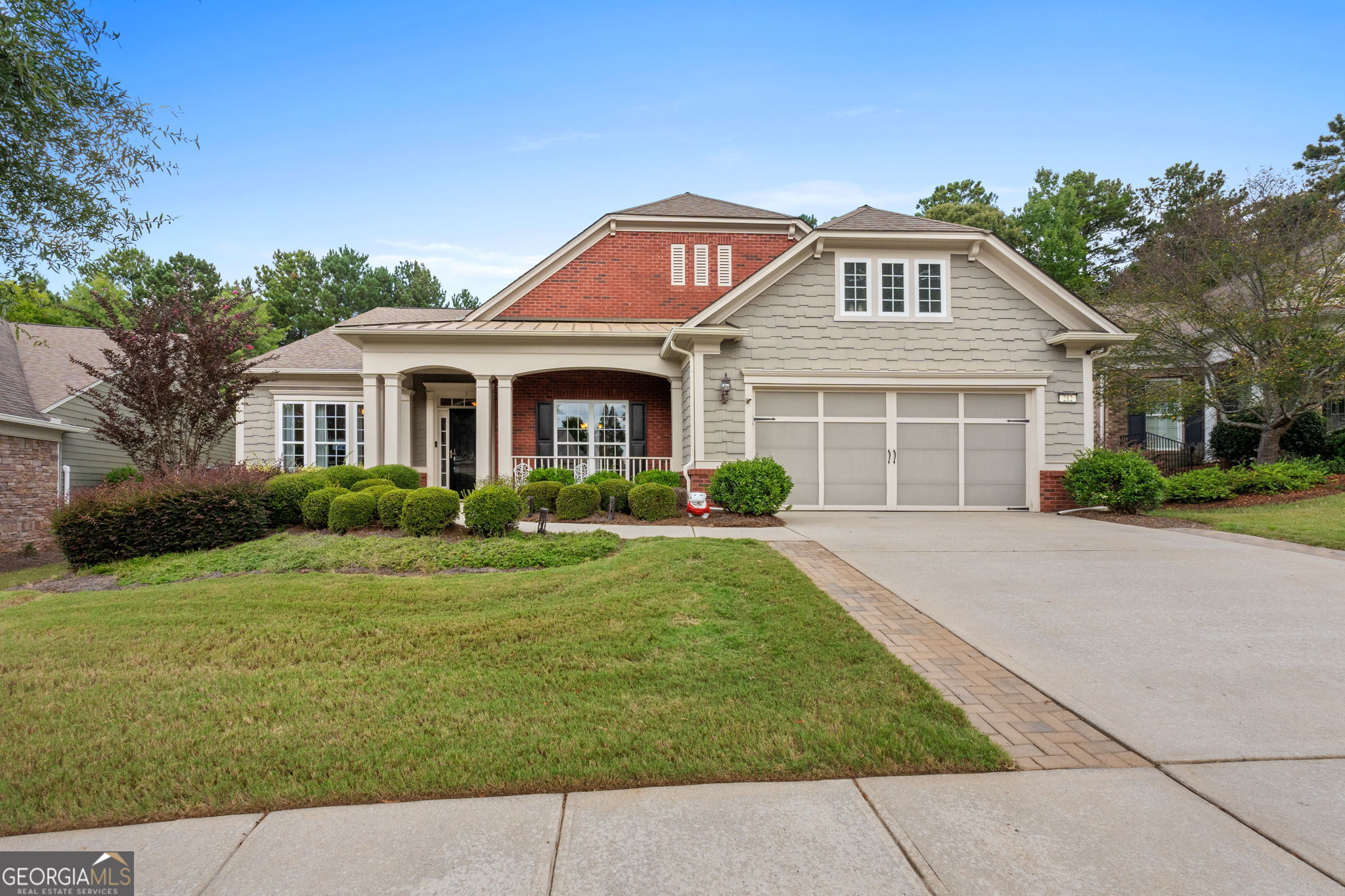 a front view of a house with a garden