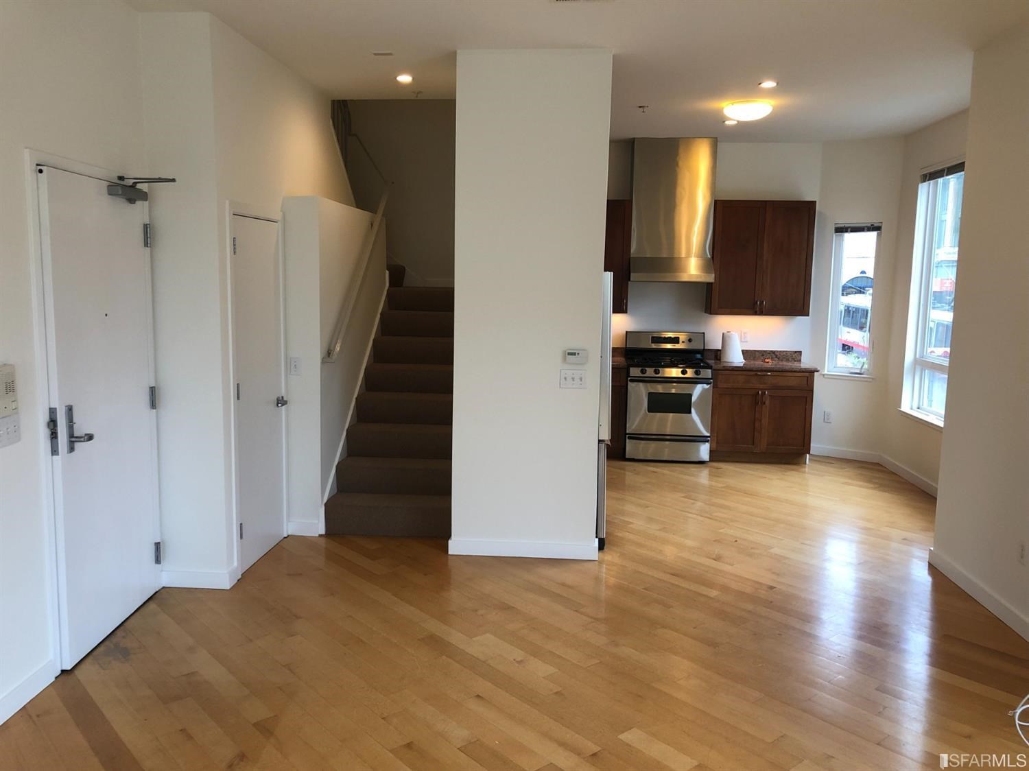 a view of a kitchen with a stove cabinets and a wooden floor