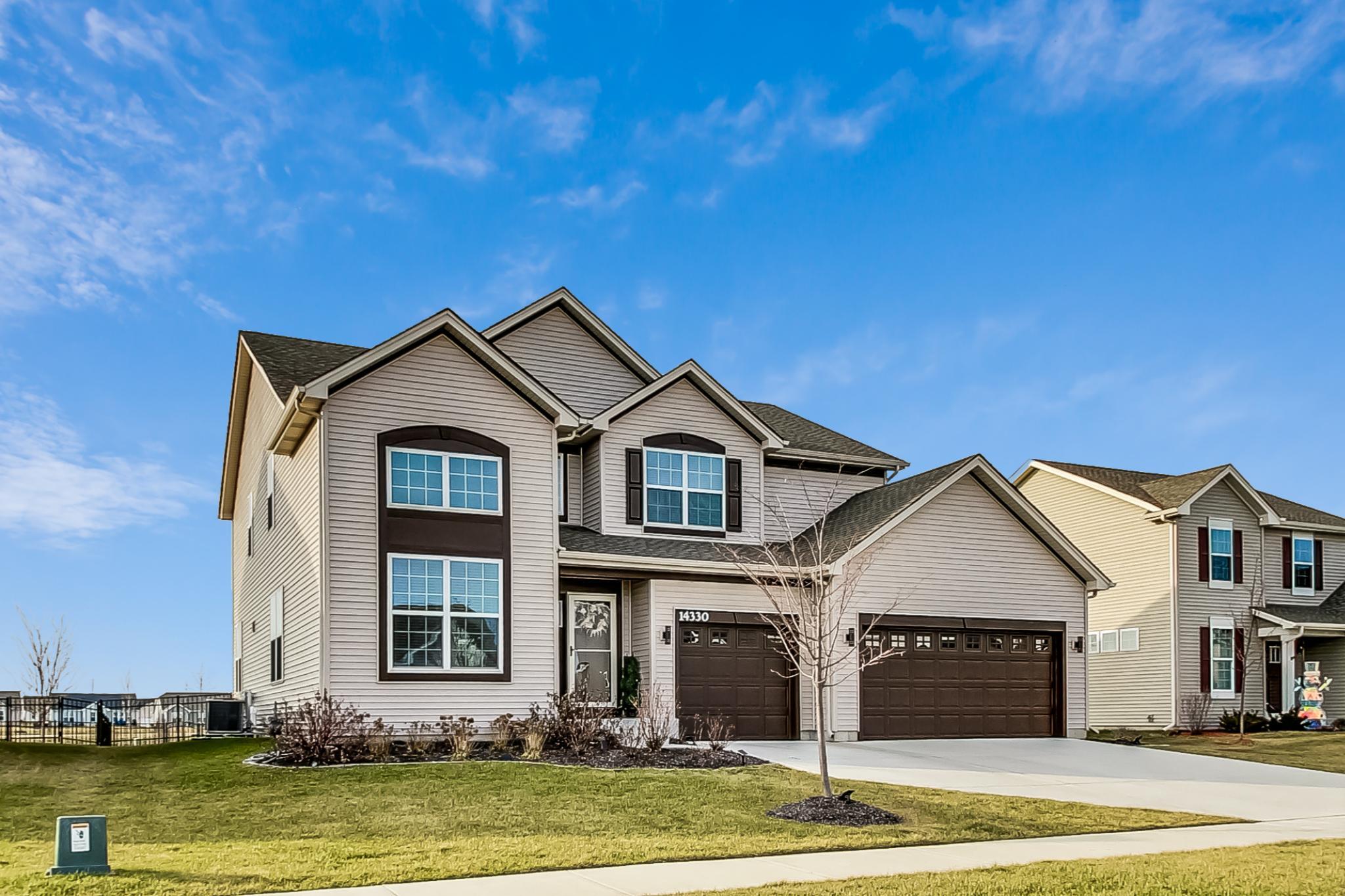 a front view of a house with a yard