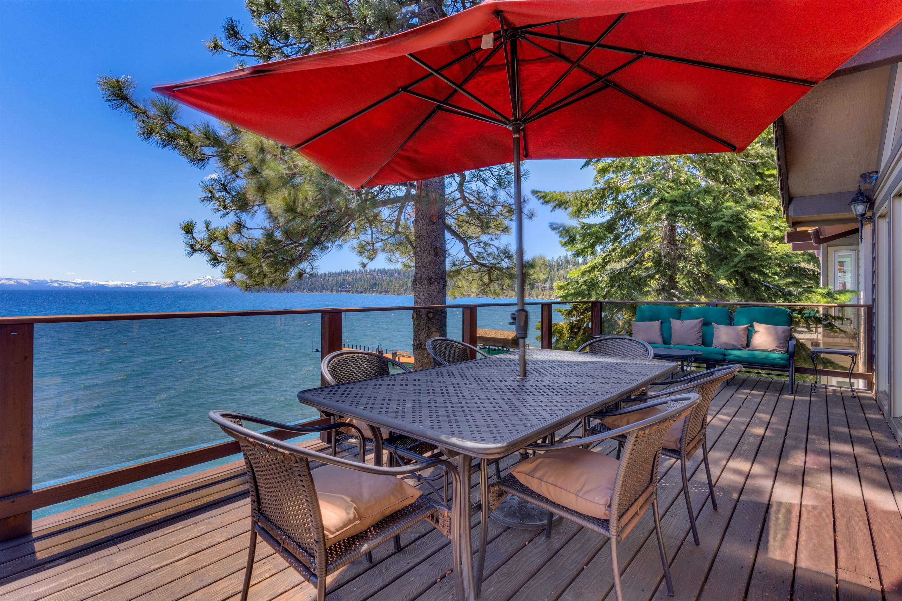 a view of balcony with table and chairs under an umbrella