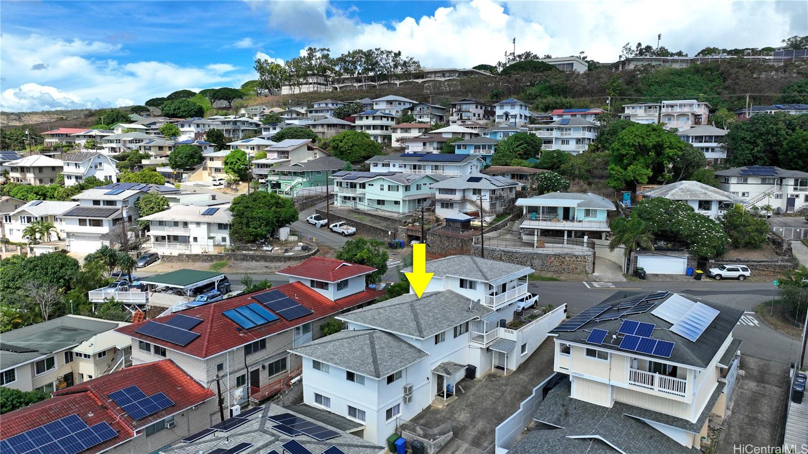 an aerial view of a houses with city view