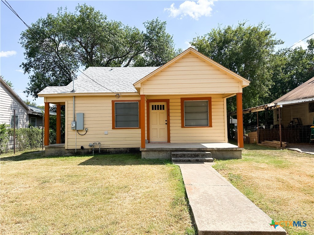 a front view of a house with a yard