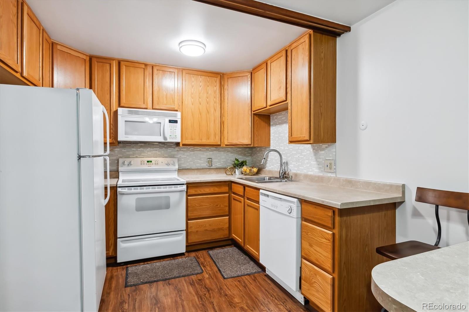 a kitchen with a refrigerator stove and sink