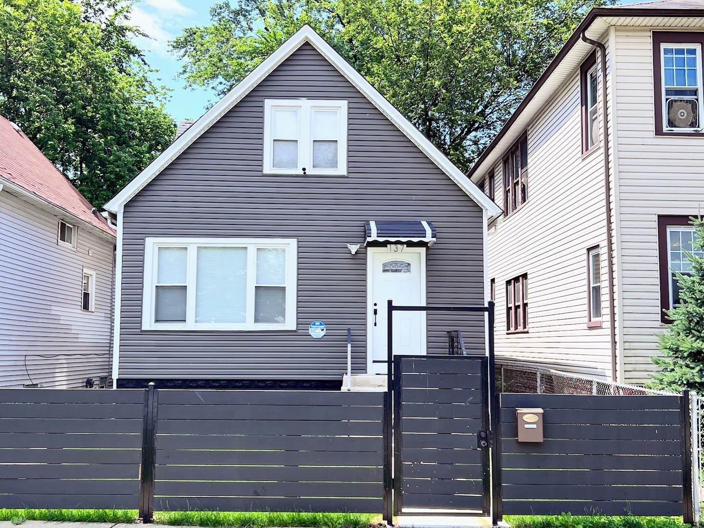 a view of a house with wooden fence