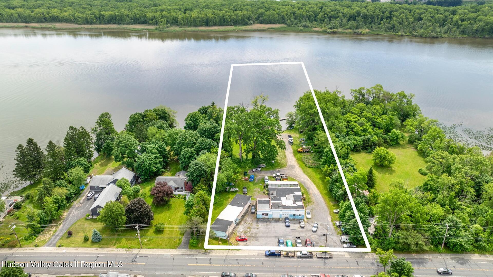 an aerial view of a house with a yard and lake view