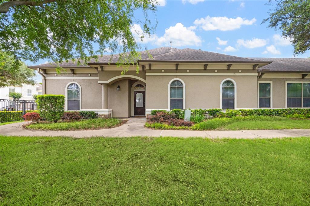 a front view of a house with a garden and yard