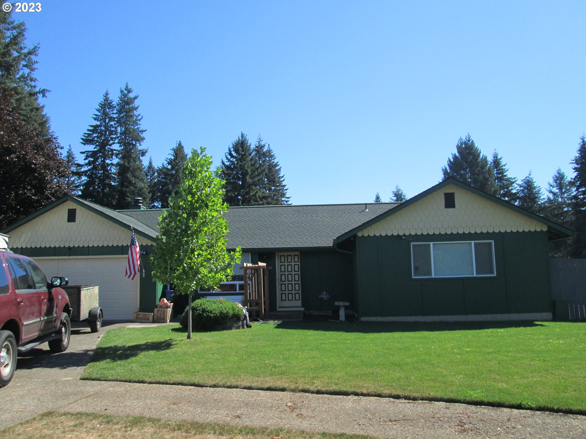 a front view of a house with a garden and yard