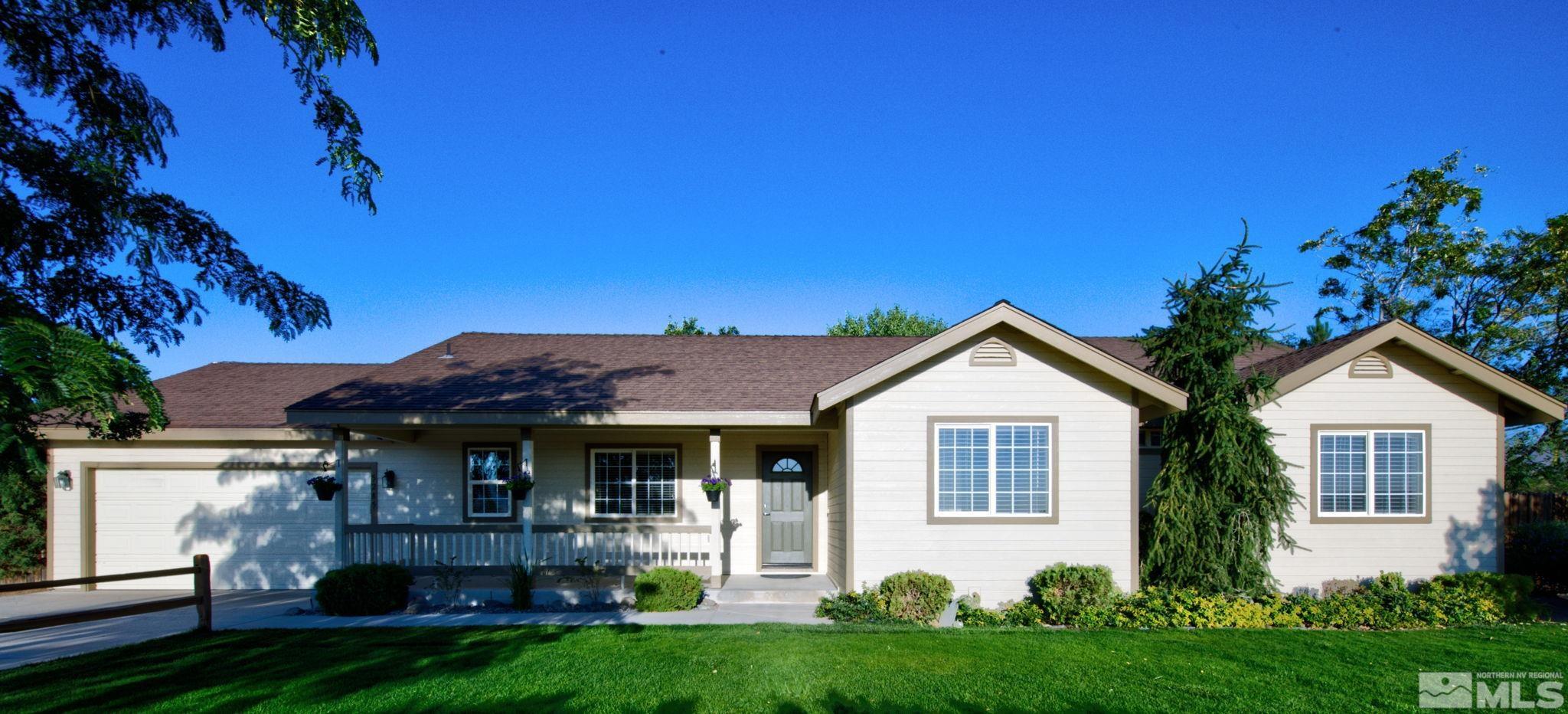 a front view of house with yard and green space