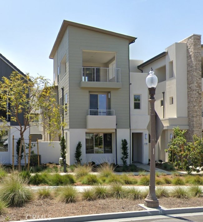 a front view of a house with swimming pool and outdoor seating