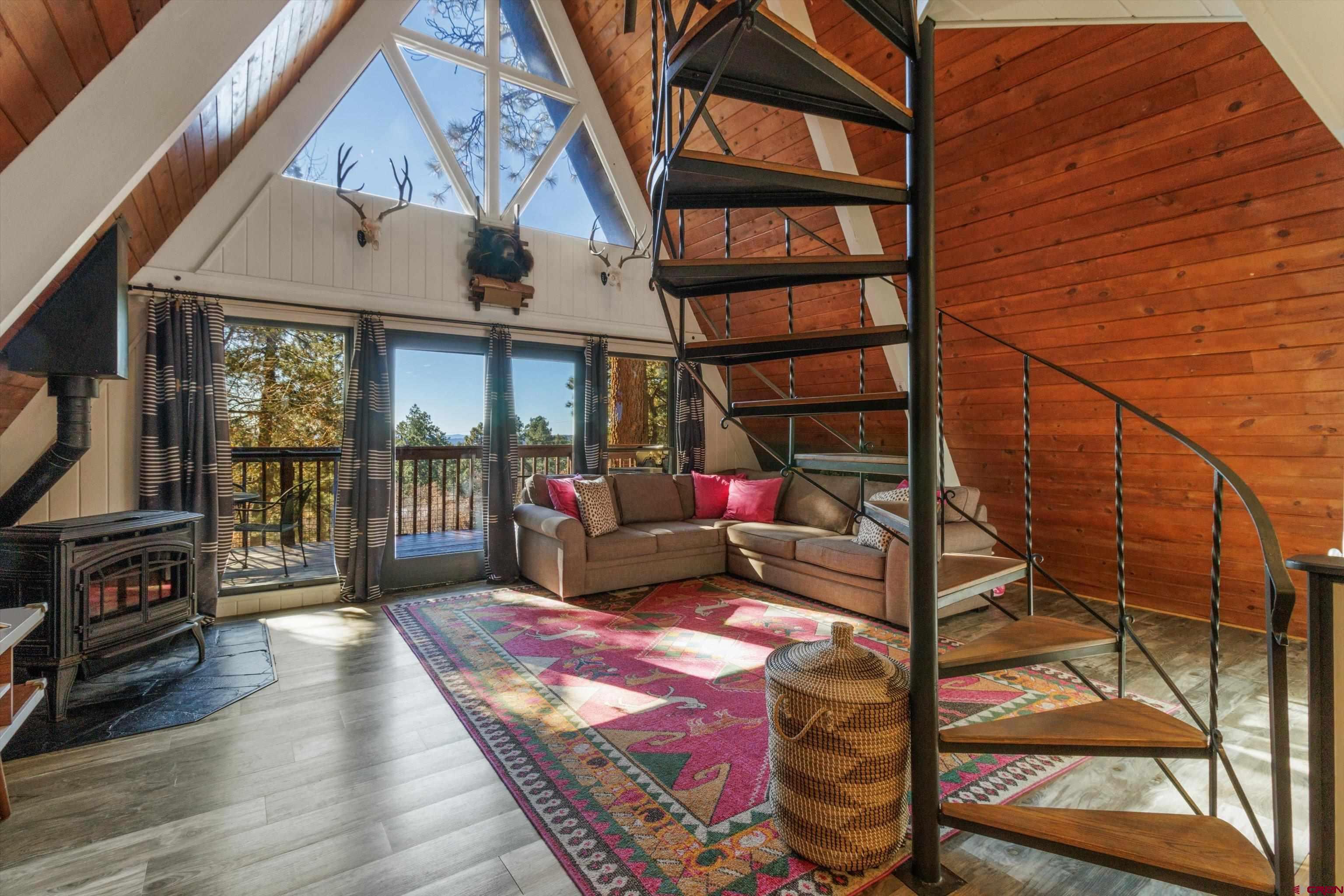 a living room with wooden floor and a book shelf