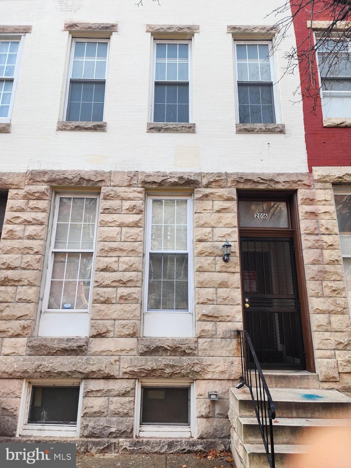 a front view of a building with a brick wall