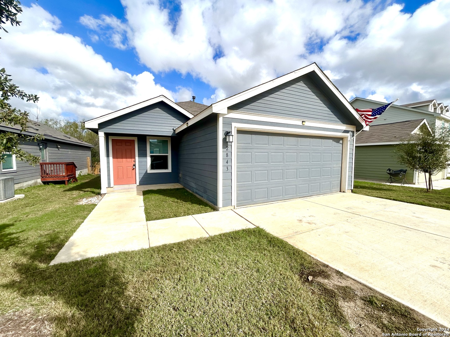 a front view of a house with a yard and garage