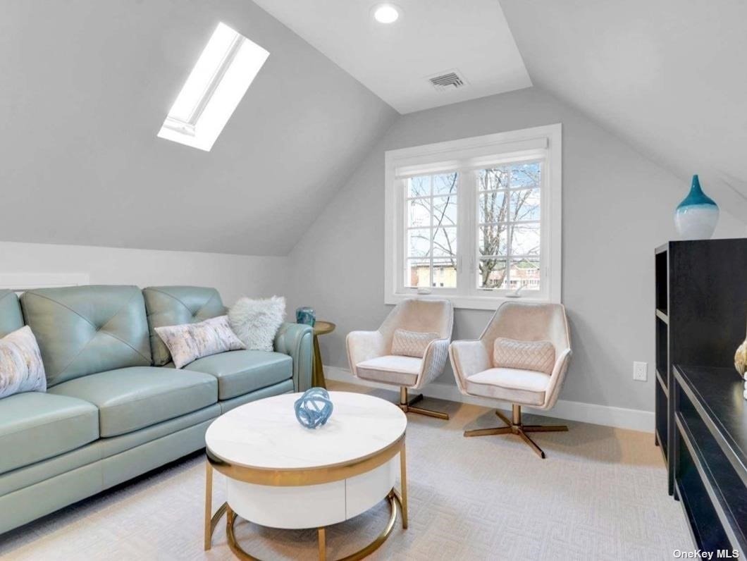 a living room with furniture a air conditioner and a window