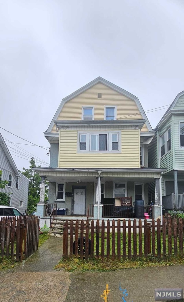 a front view of a residential apartment building with a yard