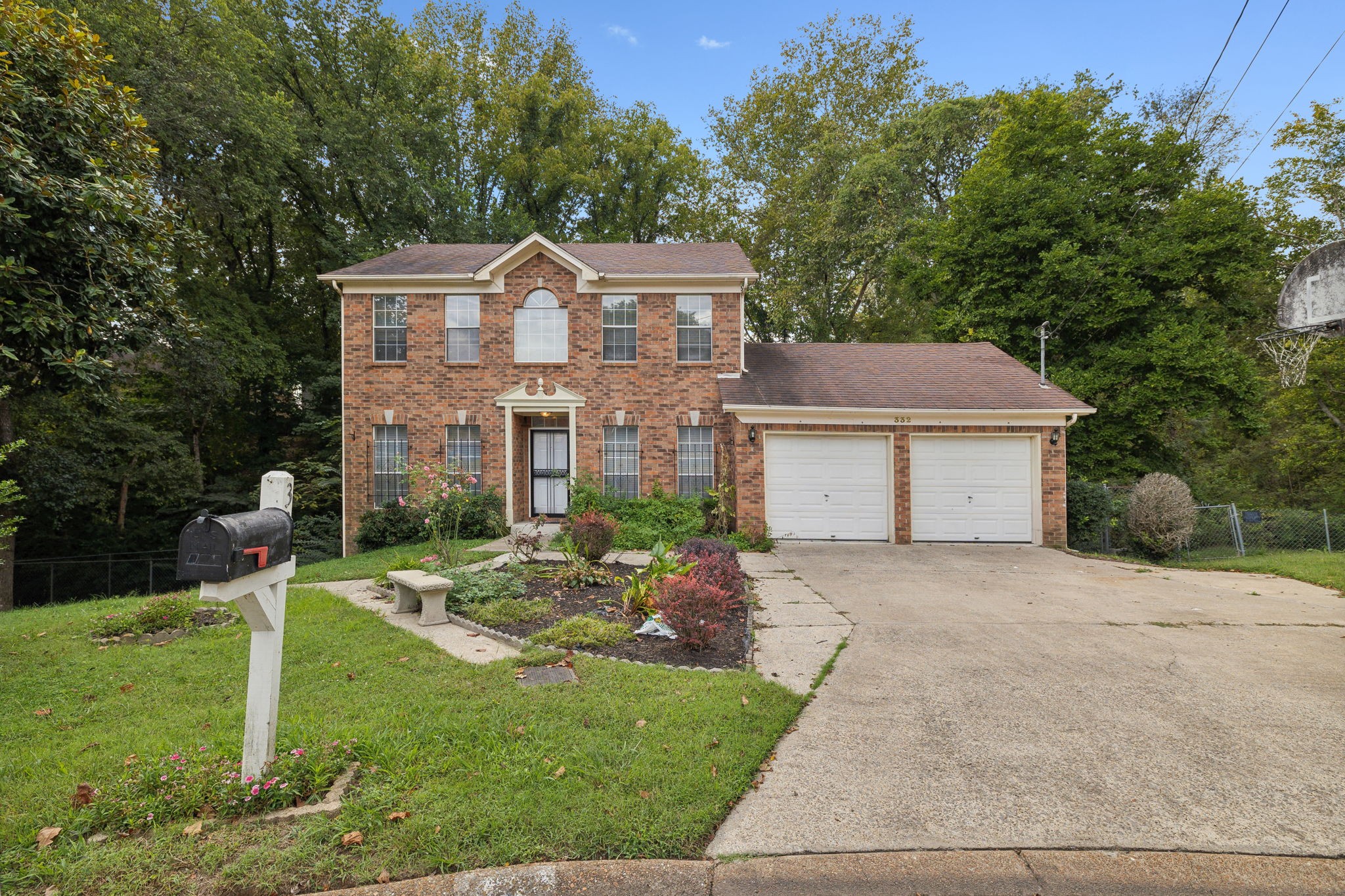 a aerial view of a house with a yard and large tree