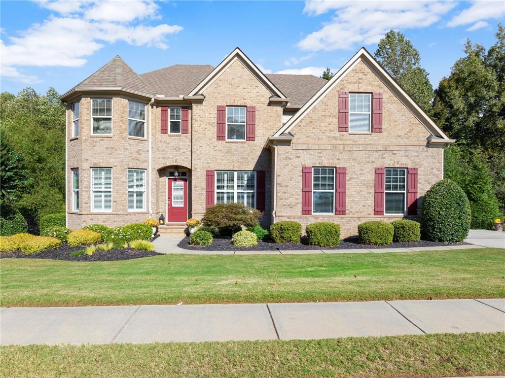 a front view of a house with a yard