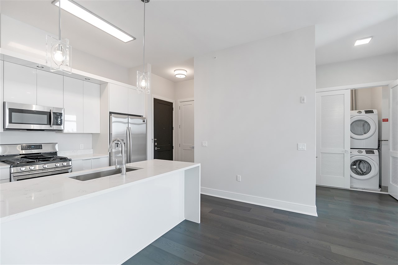 a kitchen with stainless steel appliances a refrigerator and a stove