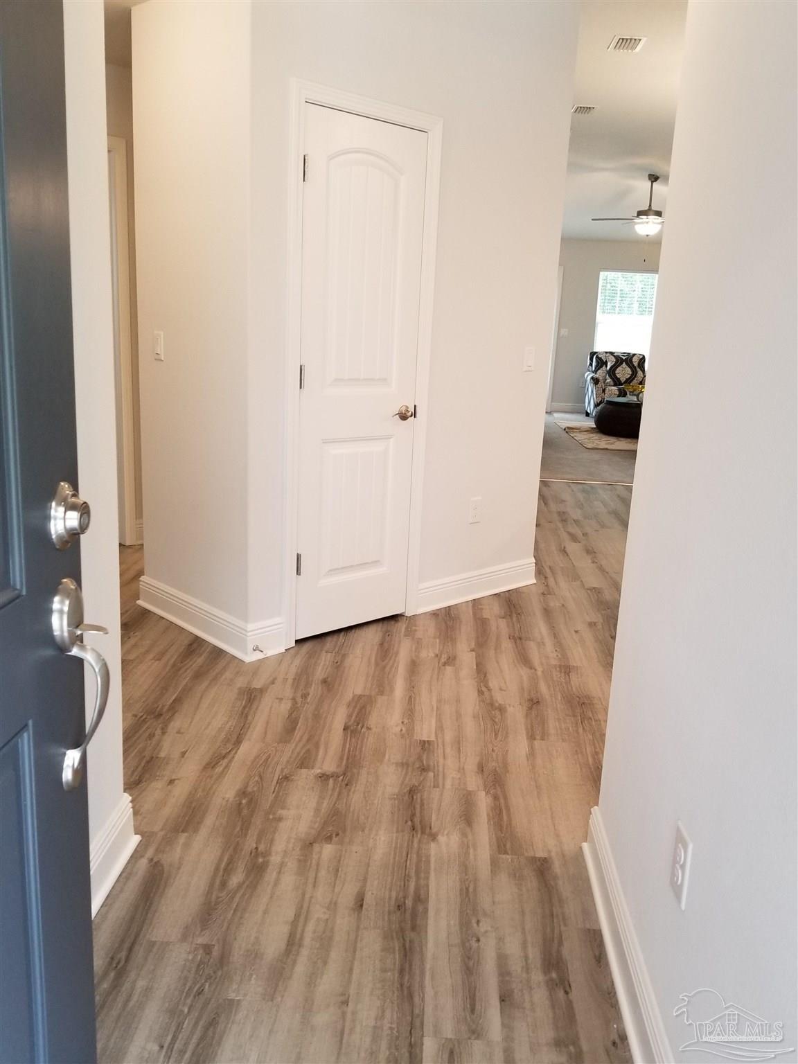 wooden floor in a hall with an entryway