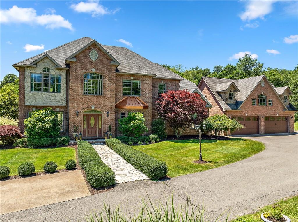 a front view of house with yard and green space