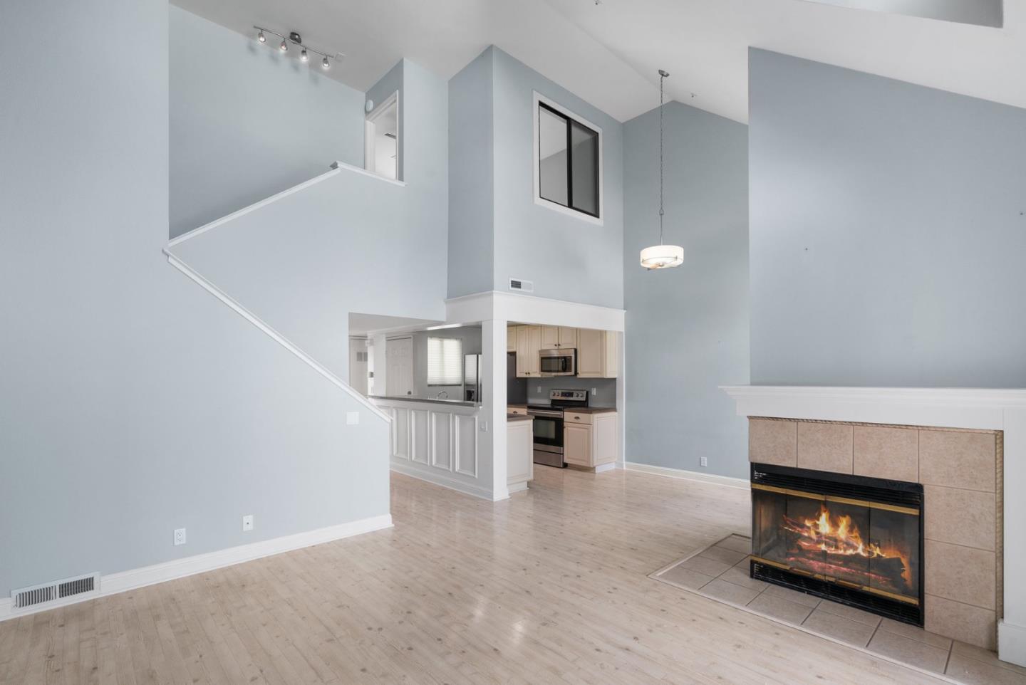 a view of a kitchen with a sink and a fireplace