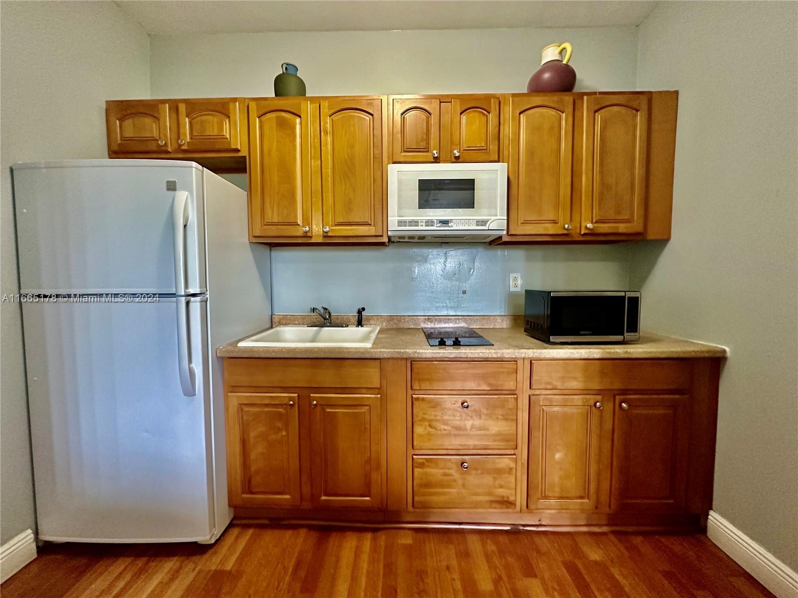 a kitchen with stainless steel appliances granite countertop a refrigerator and a stove