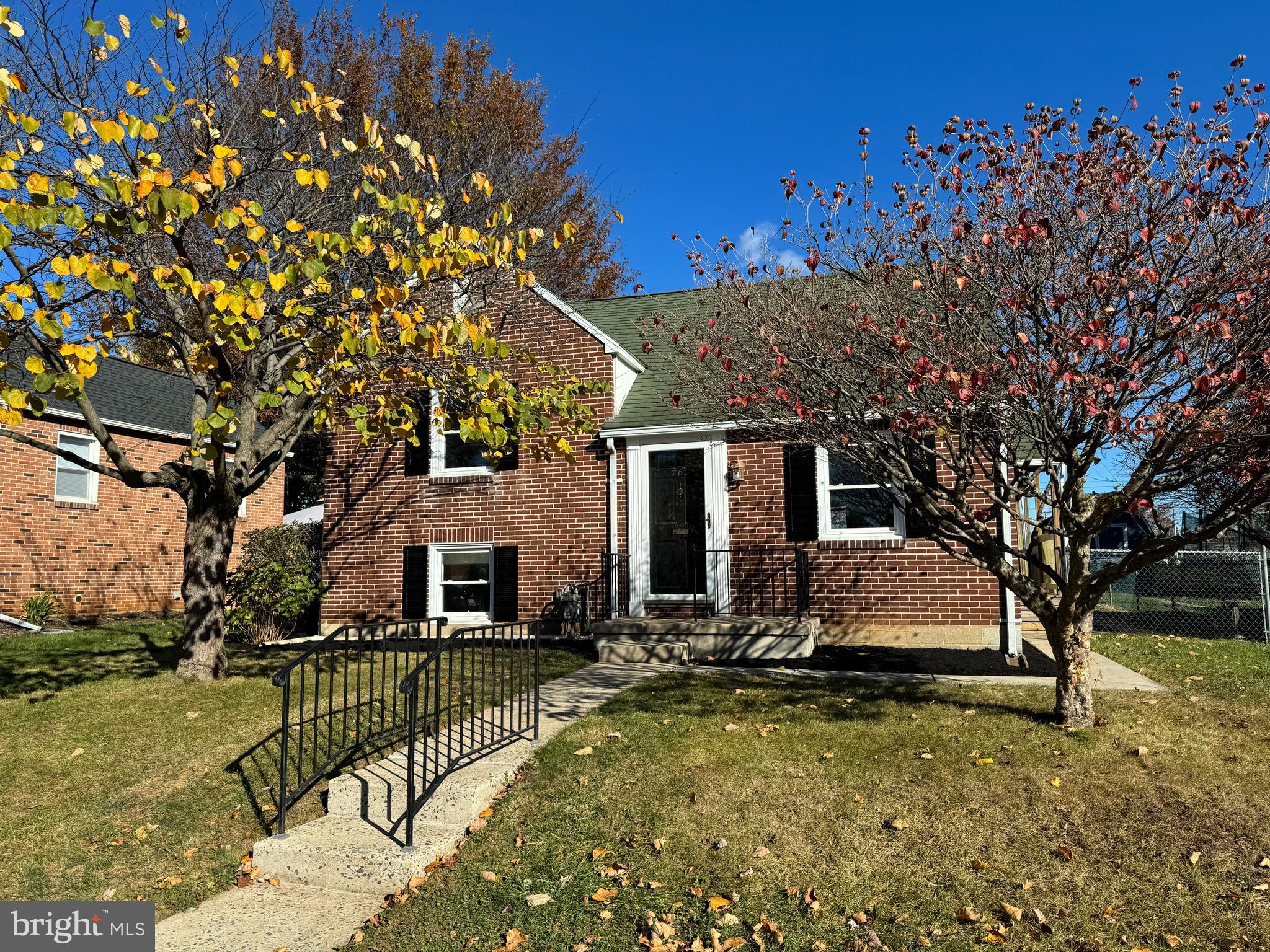 front view of a house with a tree