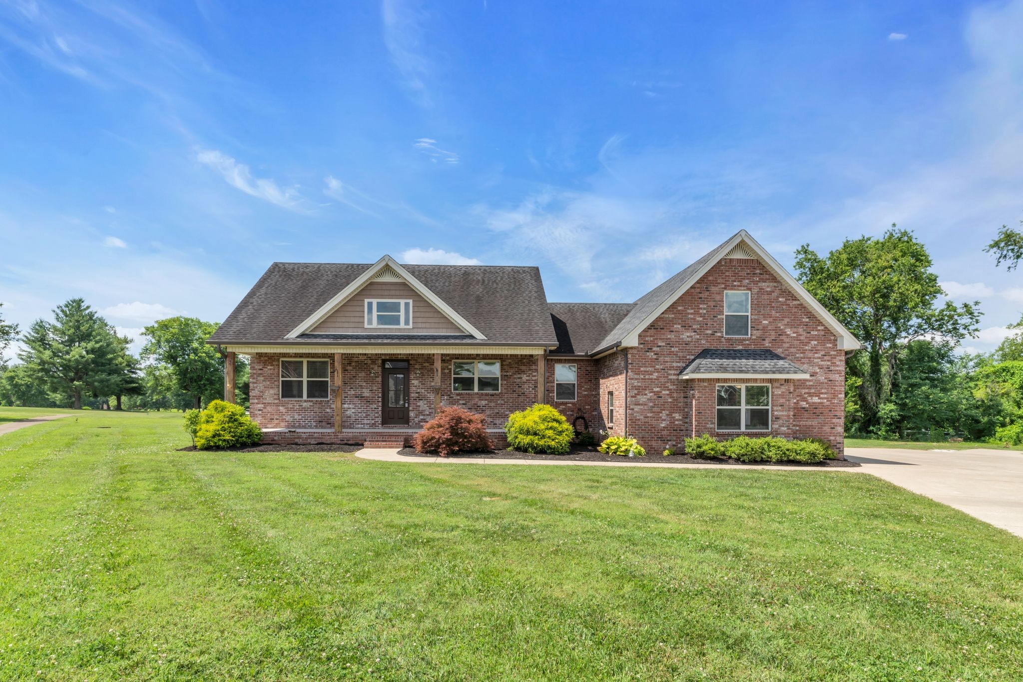 a front view of house with yard and green space