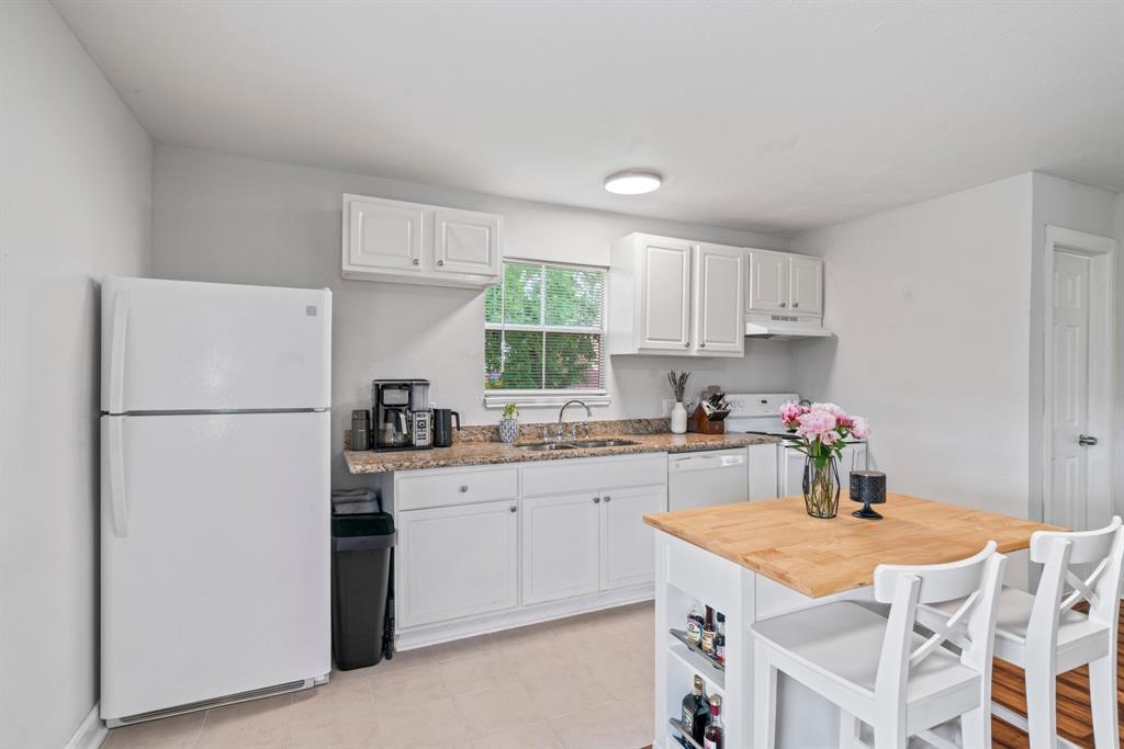 a kitchen with a white cabinets and white appliances