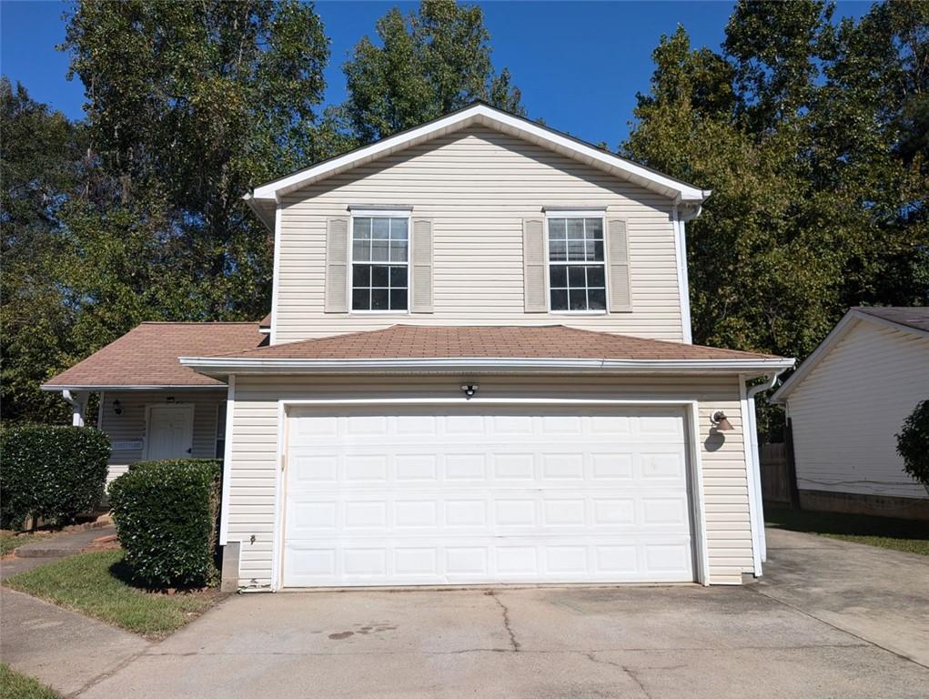 a front view of a house with a garage