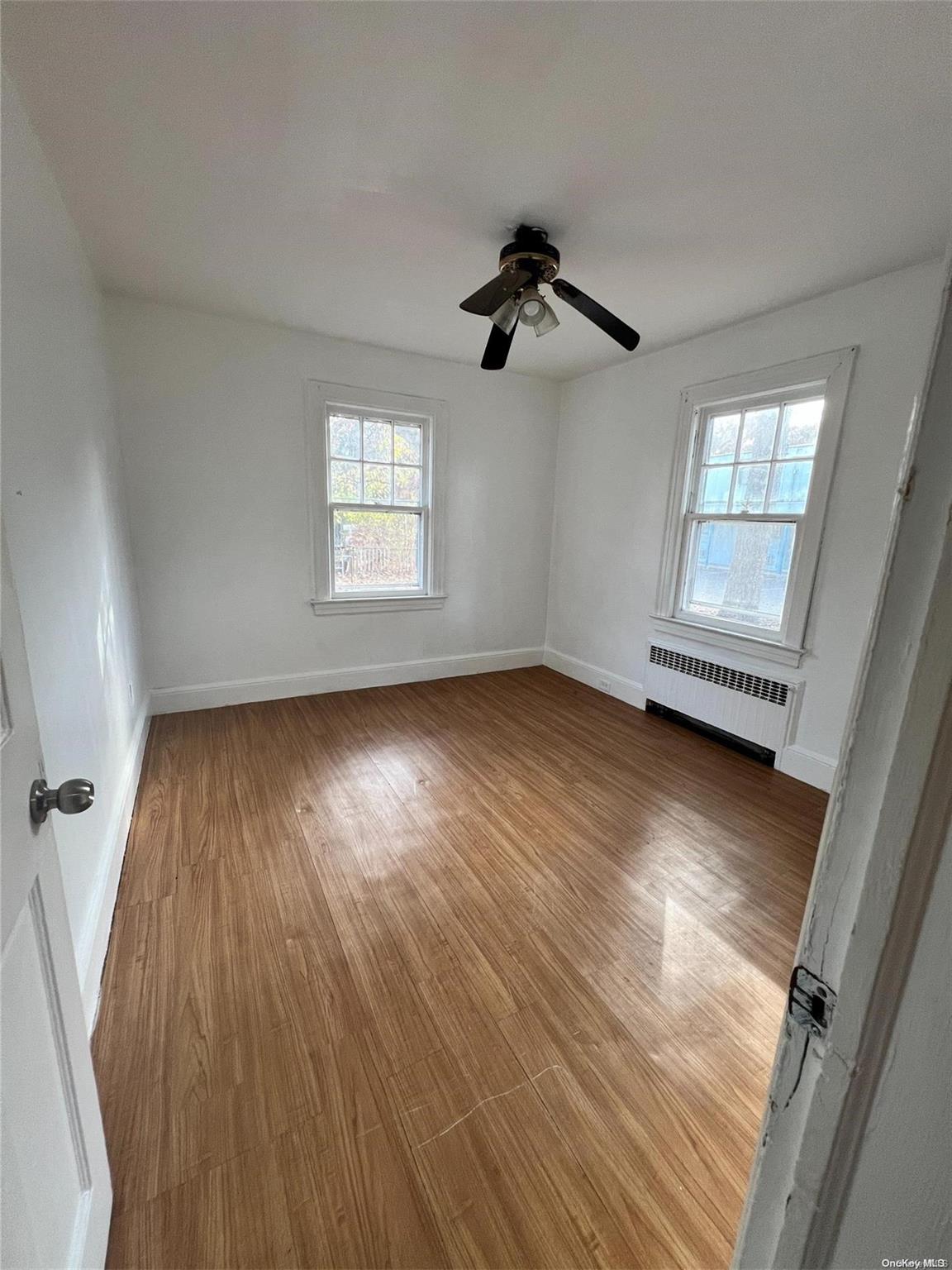 wooden floor in an empty room with a window